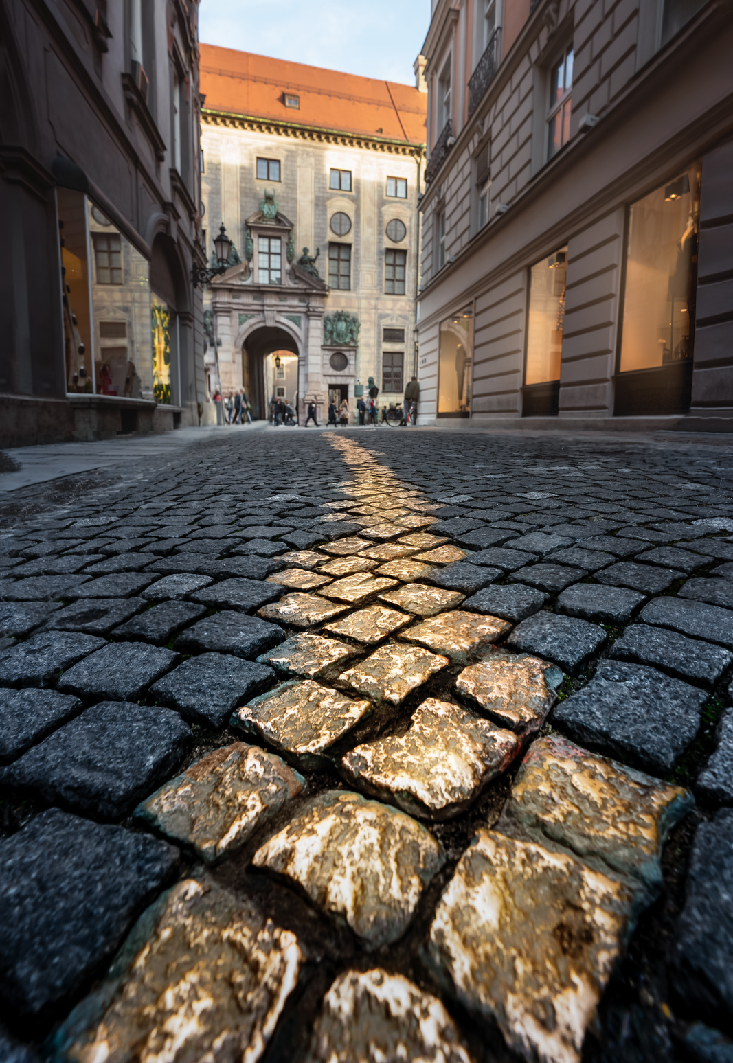 Golden cobblestones at Viscardigasse - people used this alley to avoid giving a salute in front of nazi soldiers - Munich, Bavaria, Germany